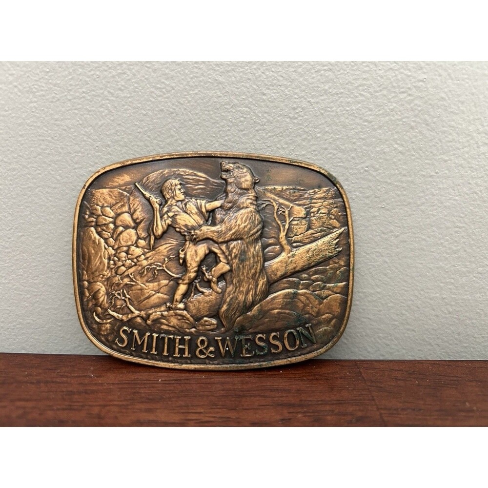 Vintage 1978 Smith & Wesson Belt Buckle “The Last Cartridge” Brass Bear Western
